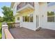 Lovely deck area with wood flooring, an entryway door, and a balcony above, perfect for entertaining at 2247 Eagles Nest Dr, Lafayette, CO 80026