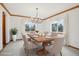 Bright dining room features a chandelier, wood trim, large windows, and neutral decor at 2247 Eagles Nest Dr, Lafayette, CO 80026