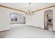 Bright dining room features neutral carpet, chandelier, and easy access to other rooms at 2247 Eagles Nest Dr, Lafayette, CO 80026