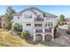 Rear exterior view showcasing a three-story home with multiple decks and patios at 2247 Eagles Nest Dr, Lafayette, CO 80026