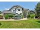 Charming home showcasing lush landscaping and a well-maintained lawn, enhancing curb appeal at 2247 Eagles Nest Dr, Lafayette, CO 80026