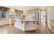Bright kitchen with granite counters, stainless appliances, hardwood floors, and a center island with cooktop at 2247 Eagles Nest Dr, Lafayette, CO 80026