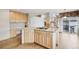 Open kitchen with granite counters, hardwood floors, and center island with cooktop at 2247 Eagles Nest Dr, Lafayette, CO 80026