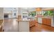 Open kitchen layout with island gas cooktop and adjacent living area at 2247 Eagles Nest Dr, Lafayette, CO 80026