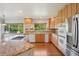 Bright kitchen featuring granite countertops, hardwood floors, and stainless steel appliances at 2247 Eagles Nest Dr, Lafayette, CO 80026