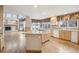 Open kitchen with granite counters, hardwood floors, and breakfast nook overlooking backyard at 2247 Eagles Nest Dr, Lafayette, CO 80026