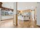 Bright kitchen with hardwood floors, granite counters, stainless appliances, and eat-in dining area at 2247 Eagles Nest Dr, Lafayette, CO 80026