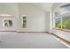 Spacious living room with large windows, neutral walls, and vaulted ceiling at 2247 Eagles Nest Dr, Lafayette, CO 80026