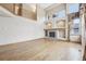 Spacious living room featuring a fireplace, hardwood floors, and soaring ceilings at 2247 Eagles Nest Dr, Lafayette, CO 80026