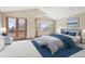 Inviting main bedroom with balcony access, vaulted ceilings, and neutral tones at 2247 Eagles Nest Dr, Lafayette, CO 80026