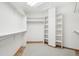 Organized walk-in closet with built-in shelves, and hanging rods for efficient storage at 2247 Eagles Nest Dr, Lafayette, CO 80026