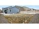Large backyard featuring a lawn, patio area, and privacy fence at 309 Spruce St, Bennett, CO 80102