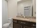 Bathroom featuring granite vanity top and modern fixtures at 309 Spruce St, Bennett, CO 80102