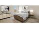 Well-lit bedroom with decorative wall art, side tables, and comfy bed at 309 Spruce St, Bennett, CO 80102