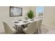 Dining room with stylish table set, modern decor, and lots of natural light at 309 Spruce St, Bennett, CO 80102