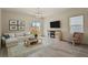 Bright living room with modern finishes, neutral colors, and a cozy fireplace at 309 Spruce St, Bennett, CO 80102