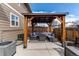 Cozy backyard patio featuring a wooden pergola with an outdoor seating area perfect for relaxation and entertainment at 256 Ash St, Bennett, CO 80102
