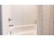 Clean and simple white bathtub with showerhead and tiled wall at 256 Ash St, Bennett, CO 80102