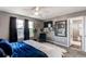 Primary bedroom featuring a ceiling fan and large windows to let in plenty of natural light at 256 Ash St, Bennett, CO 80102