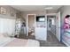 Bright bedroom with a decorative mirror, tv, and open doorway to other parts of the house at 256 Ash St, Bennett, CO 80102