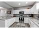 Modern kitchen featuring stainless steel appliances, granite countertops, and ample cabinetry for storage at 256 Ash St, Bennett, CO 80102