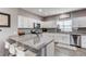 Spacious kitchen with granite countertops, stainless steel appliances, and ample white cabinetry at 256 Ash St, Bennett, CO 80102