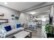 Open-concept living and dining area with wood floors seamlessly connecting to the kitchen at 256 Ash St, Bennett, CO 80102