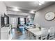 Bright living area featuring hardwood floors, a fireplace, and a dining table with seating, creating a warm ambiance at 256 Ash St, Bennett, CO 80102