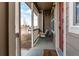 Charming covered porch with a swing, offering a relaxing outdoor space and lovely view and an inviting 'welcome' mat at 256 Ash St, Bennett, CO 80102