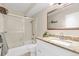 Updated bathroom with granite countertop and shower over tub with sliding glass door at 3022 S Wheeling Way # 107, Aurora, CO 80014