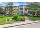 Multi-story building with well-manicured lawn and mature trees at 3022 S Wheeling Way # 107, Aurora, CO 80014