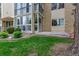 Well-maintained exterior view featuring an enclosed patio and landscaped greenery at 3022 S Wheeling Way # 107, Aurora, CO 80014