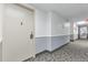 Hallway leading to units with neutral paint and carpet at 3022 S Wheeling Way # 107, Aurora, CO 80014