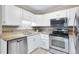 Kitchen with stainless steel appliances, tile backsplash, and granite counters at 3022 S Wheeling Way # 107, Aurora, CO 80014