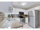 Updated kitchen with stainless steel appliances and modern finishes at 3022 S Wheeling Way # 107, Aurora, CO 80014