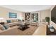 Bright living room featuring a neutral palette, area rug, and balcony access at 3022 S Wheeling Way # 107, Aurora, CO 80014