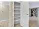 A hallway pantry with white shelving to keep your space clutter free at 3022 S Wheeling Way # 107, Aurora, CO 80014