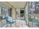Relaxing enclosed patio with tile flooring, comfortable seating, and scenic views at 3022 S Wheeling Way # 107, Aurora, CO 80014