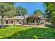 Lovely backyard with a spacious patio, outdoor furniture, a grill, and a lush green lawn at 13 Club Ln, Littleton, CO 80123