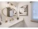 Elegant bathroom with a gold-framed oval mirror, a floral picture, and modern lighting at 13 Club Ln, Littleton, CO 80123