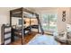 Stylish bedroom featuring a lofted bed and desk, wood floors, a beanbag chair, and natural light at 13 Club Ln, Littleton, CO 80123