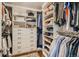 A walk-in closet with built-in shelving, drawers, hanging rods, and ample storage for clothes and accessories at 13 Club Ln, Littleton, CO 80123