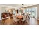 Elegant dining room with hardwood floors, chandelier, and adjacent sitting area with large windows at 13 Club Ln, Littleton, CO 80123