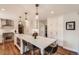 Bright kitchen with a large quartz island, stainless steel appliances, and custom white cabinetry at 13 Club Ln, Littleton, CO 80123