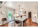 Spacious kitchen with a large island, quartz countertops, white cabinets, and access to the backyard at 13 Club Ln, Littleton, CO 80123