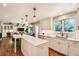 Well-lit kitchen featuring white cabinets, granite counters, stainless steel appliances, and modern pendant lighting at 13 Club Ln, Littleton, CO 80123