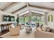 Bright living room with vaulted ceilings, large windows, comfortable seating, and access to outdoor patio at 13 Club Ln, Littleton, CO 80123