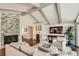 Comfortable living room with a stone fireplace, vaulted ceilings, and a built-in bar area at 13 Club Ln, Littleton, CO 80123