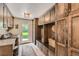 Mudroom with dark wood cabinetry, bench seating, a utility sink with butcher block countertop, and washer and dryer at 13 Club Ln, Littleton, CO 80123