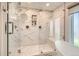 Bright glass shower with marble-style tiles, dual shower heads, a built-in niche, and a built-in bench at 13 Club Ln, Littleton, CO 80123